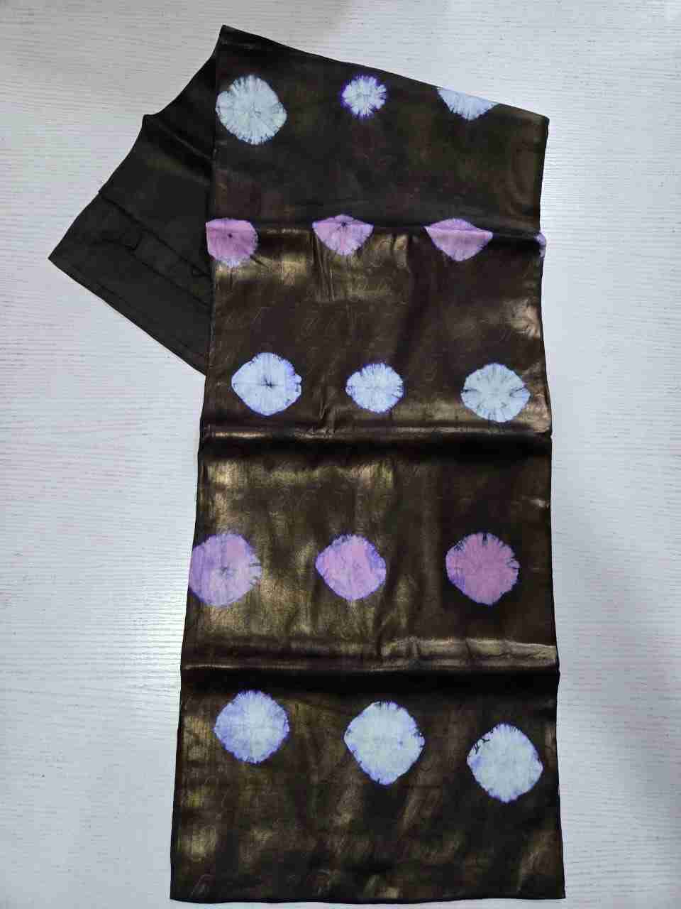 Handcrafted tie-dye Kampala fabric showing rows of dusty orchid-pink and lavender-white bursts over a bronze-sheen base detailed with faint vertical abstract stamps
